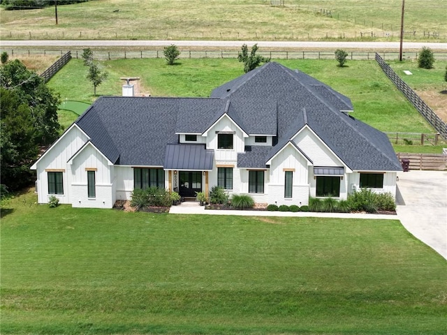 6038 Rain Meadow Dr, College Station, TX 77845 - modern farmhouse style home featuring a shingled roof, board and batten siding, a standing seam roof, and metal roof