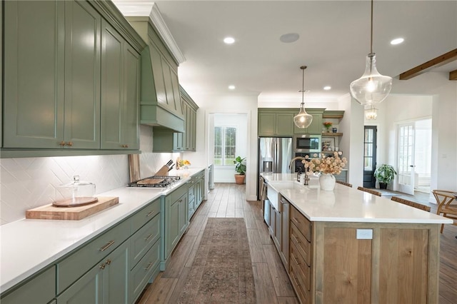 6038 Rain Meadow Dr, College Station, TX 77845 - kitchen with green cabinetry, stainless steel appliances, backsplash, dark wood-style flooring, and light countertops