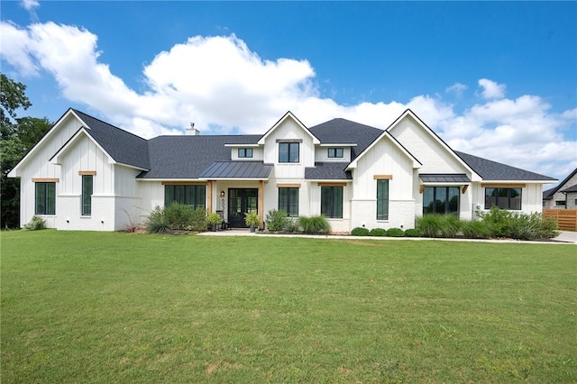 6038 Rain Meadow Dr, College Station, TX 77845 - modern farmhouse style home with board and batten siding, a standing seam roof, and a front lawn