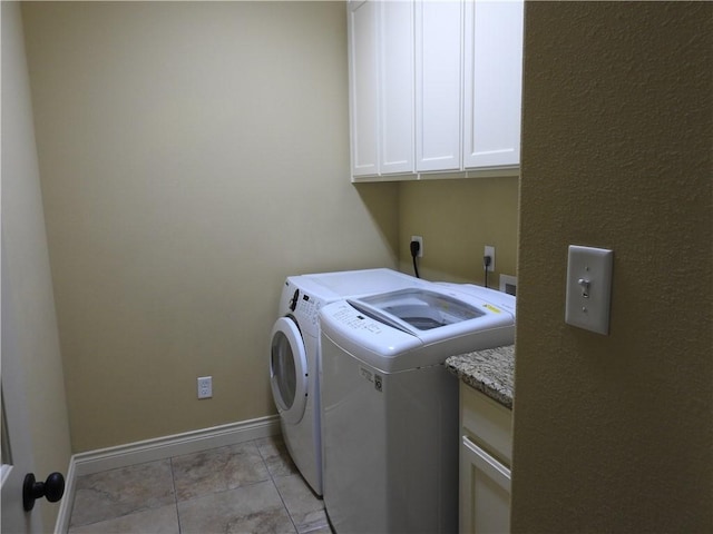 2622 Forest Oaks Dr, College Station, TX 77845 - laundry area with cabinet space, washing machine and dryer, and light tile patterned floors