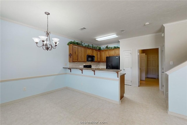 kitchen with an inviting chandelier, kitchen peninsula, pendant lighting, black appliances, and ornamental molding