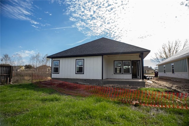 back of house with a patio area and a lawn