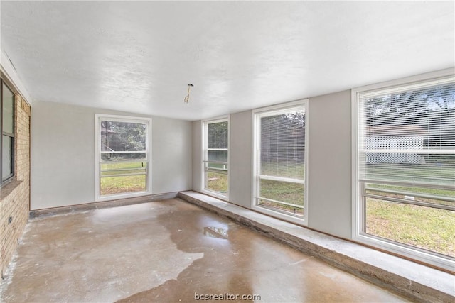 unfurnished sunroom featuring a wealth of natural light