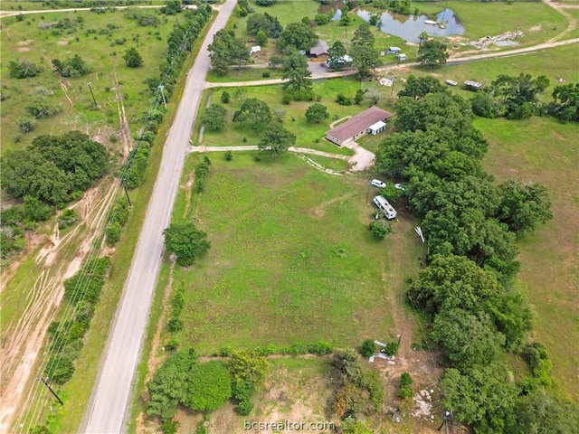 drone / aerial view with a water view and a rural view