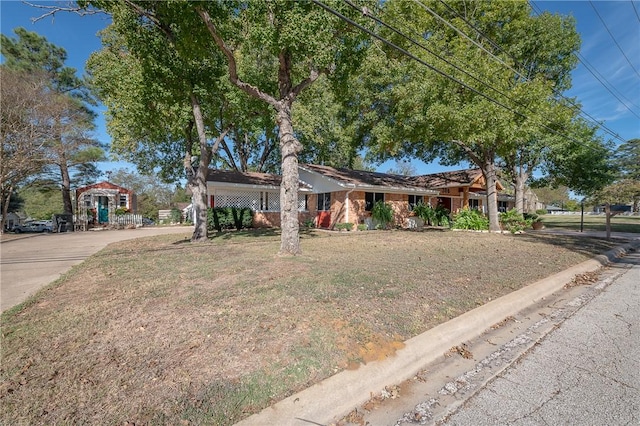 ranch-style home with a front lawn