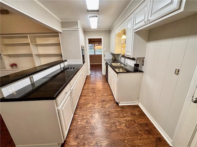 kitchen featuring crown molding, white cabinetry, sink, and dark wood-type flooring