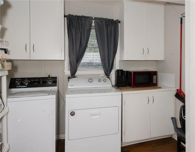 clothes washing area featuring dark wood-type flooring, separate washer and dryer, and cabinets