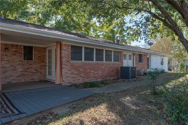 view of front of property featuring cooling unit and a wooden deck