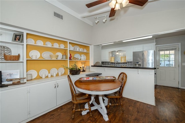 dining area with ceiling fan and dark wood-type flooring