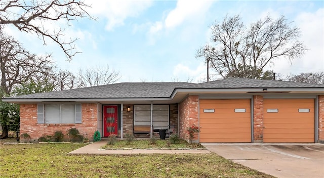 4200 Milam St, Bryan, TX 77801 - ranch-style house featuring brick siding, an attached garage, a front lawn, and driveway