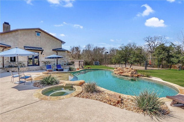 view of swimming pool featuring a fenced in pool, fence, a yard, a patio area, and an in ground hot tub