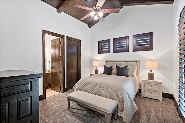 bedroom with baseboards, lofted ceiling with beams, ensuite bathroom, wooden ceiling, and carpet flooring