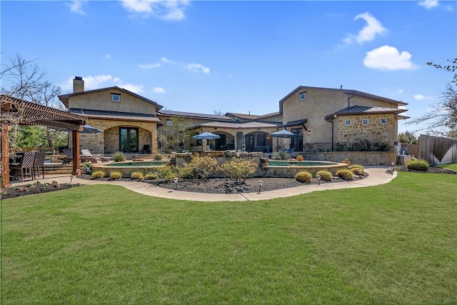 back of house featuring stucco siding, a pergola, a standing seam roof, stone siding, and a yard