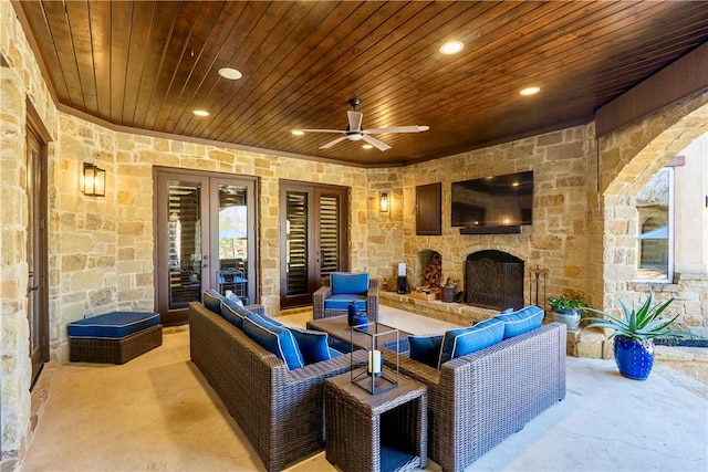 view of patio featuring an outdoor living space with a fireplace, french doors, and a ceiling fan