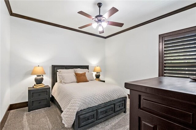 bedroom with ceiling fan, crown molding, baseboards, and carpet floors