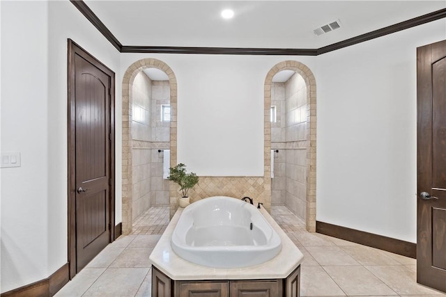 bathroom with baseboards, visible vents, ornamental molding, tile patterned floors, and a bath