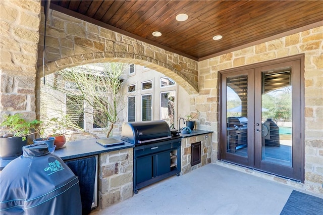 view of patio / terrace featuring area for grilling, an outdoor kitchen, and french doors