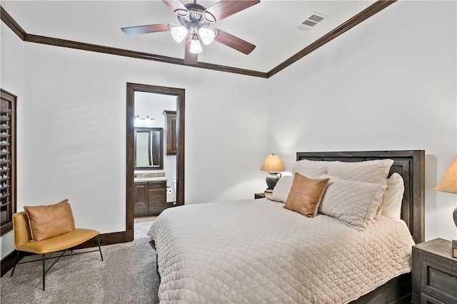 carpeted bedroom with visible vents, ensuite bath, crown molding, and baseboards