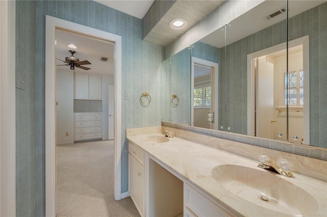 bathroom featuring ceiling fan, vanity, and a wealth of natural light