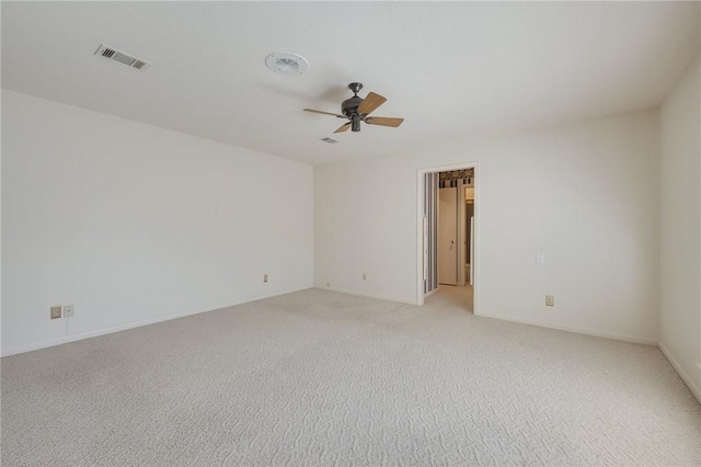 unfurnished room featuring light colored carpet and ceiling fan