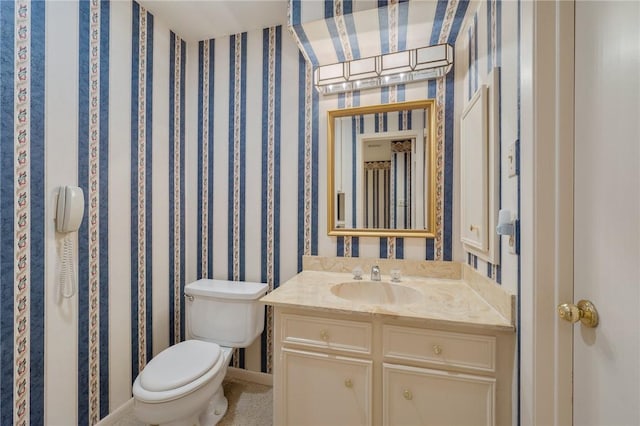 bathroom featuring vanity and toilet