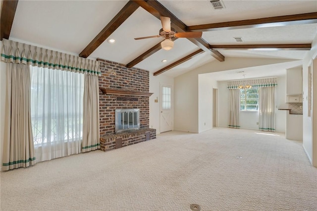 unfurnished living room with light carpet, a fireplace, lofted ceiling with beams, and ceiling fan with notable chandelier