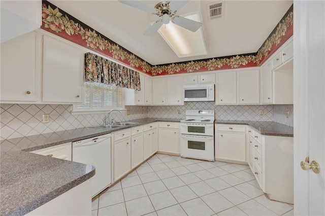 kitchen with white cabinetry, white appliances, sink, and tasteful backsplash