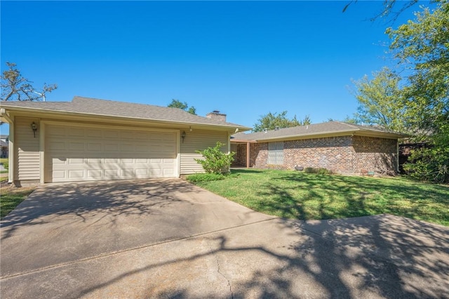 single story home with a front yard and a garage