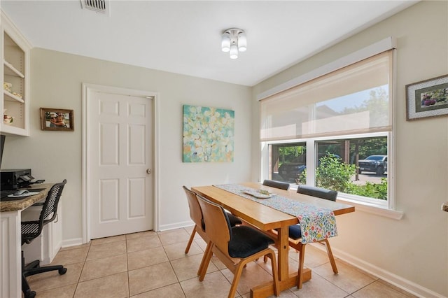 dining room with baseboards, light tile patterned flooring, and visible vents