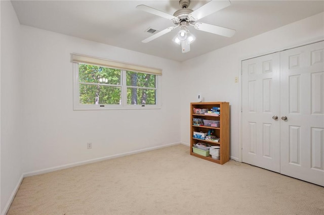 bedroom with visible vents, baseboards, a closet, and light carpet