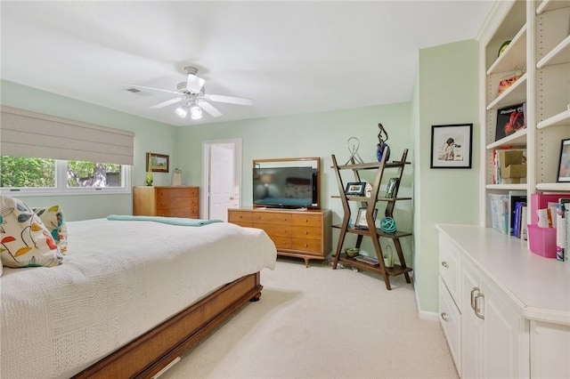 bedroom featuring baseboards, ceiling fan, light carpet, and visible vents