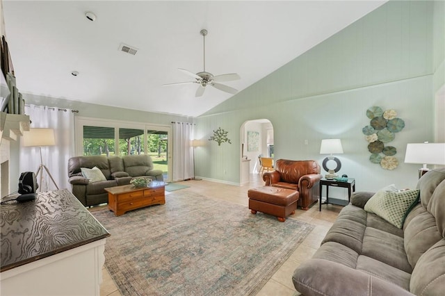 living area featuring visible vents, a ceiling fan, high vaulted ceiling, arched walkways, and light tile patterned floors