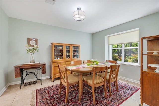dining room with baseboards, light tile patterned floors, and visible vents