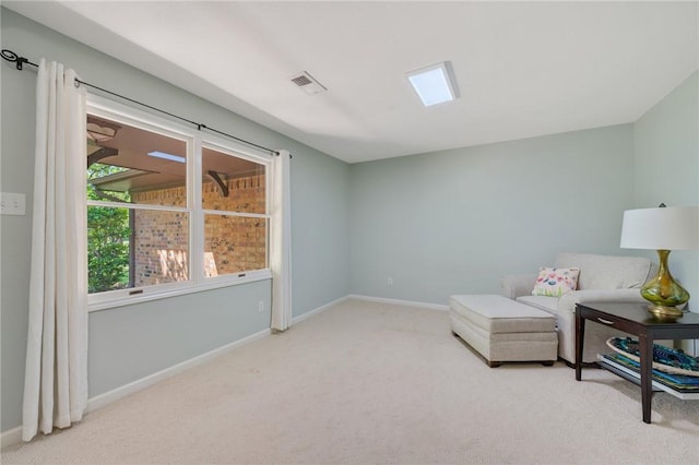 sitting room with baseboards, visible vents, and carpet