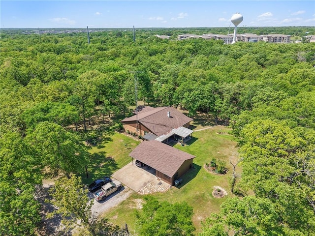 drone / aerial view with a wooded view