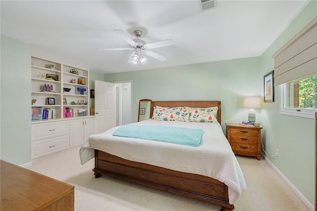 bedroom featuring visible vents, baseboards, ceiling fan, and light carpet
