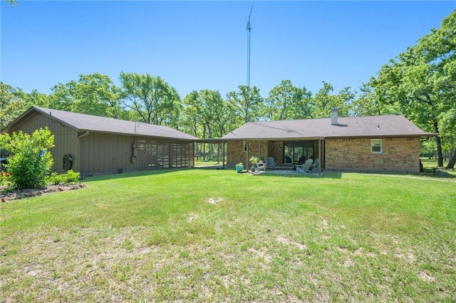 back of house with a lawn