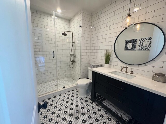 3911 Swarthmore St, Houston, TX 77005 - bathroom featuring tile walls, a stall shower, vanity, toilet, and decorative backsplash