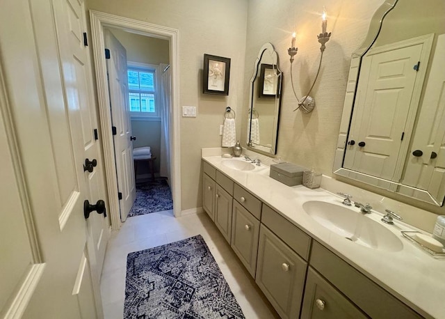 3911 Swarthmore St, Houston, TX 77005 - bathroom featuring double vanity, tile patterned floors, and baseboards