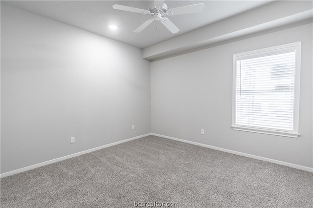 carpeted spare room featuring ceiling fan