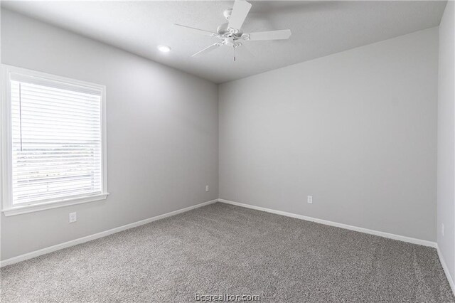 spare room with ceiling fan and carpet floors