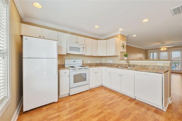 1725 Harvey Mitchell Pkwy, College Station, TX 77840 - kitchen featuring white appliances, a sink, a peninsula, crown molding, and light wood-type flooring