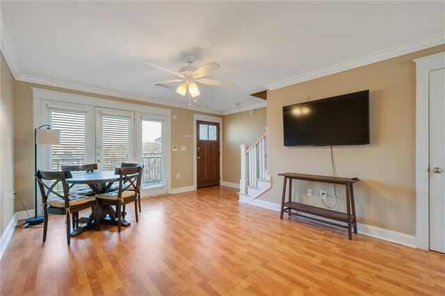 1725 Harvey Mitchell Pkwy, College Station, TX 77840 - living area featuring baseboards, stairs, light wood finished floors, and crown molding