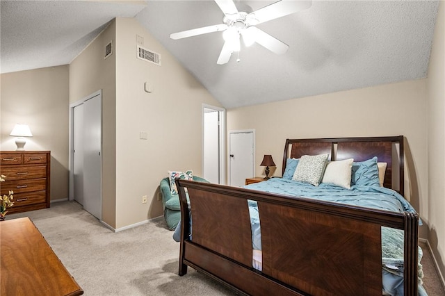 carpeted bedroom featuring a textured ceiling, ceiling fan, and lofted ceiling