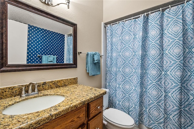 bathroom with vanity, a shower with shower curtain, and toilet