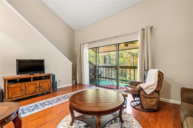 living room featuring lofted ceiling and hardwood / wood-style flooring