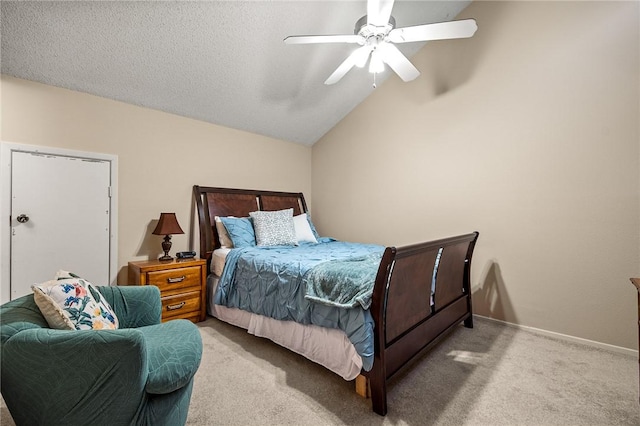 bedroom with a textured ceiling, light colored carpet, vaulted ceiling, and ceiling fan