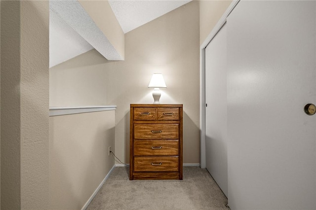 spacious closet with light colored carpet and lofted ceiling