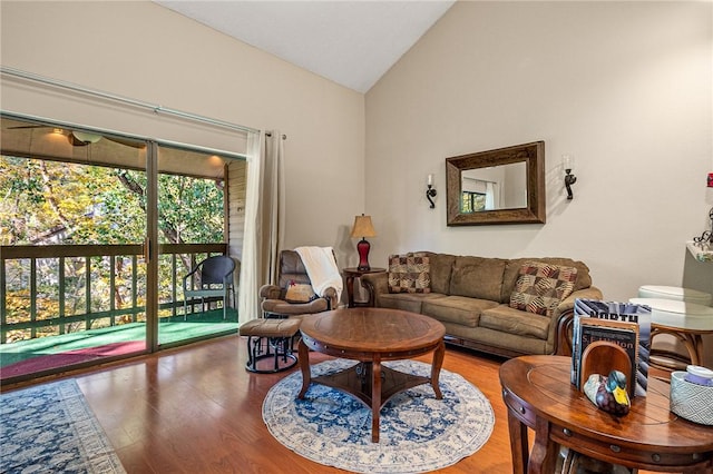 living room with high vaulted ceiling and wood-type flooring