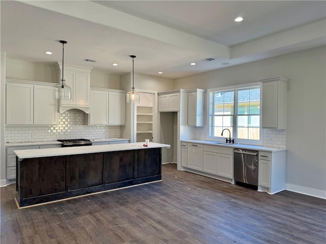 kitchen with decorative light fixtures, a center island, stainless steel appliances, and dark hardwood / wood-style floors